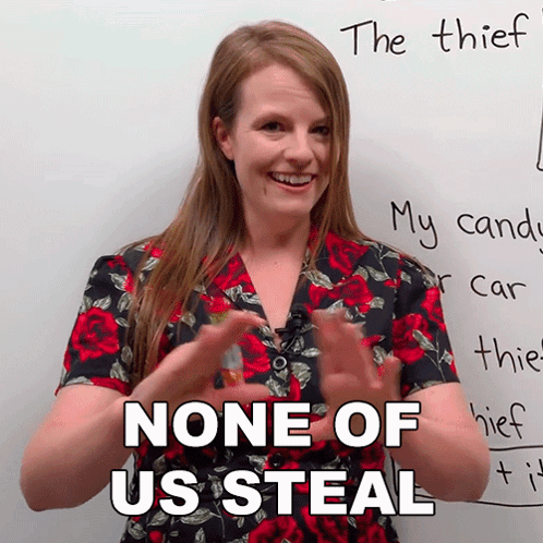 A Woman Says " None Of Us Steal " In Front Of A White Board GIF