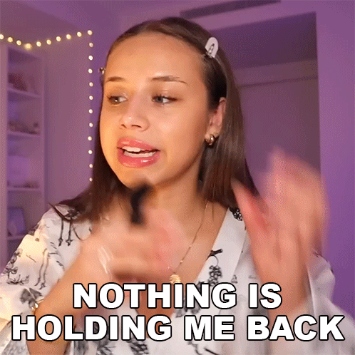 A Woman Says Nothing Is Holding Me Back In Front Of A Purple Background GIF