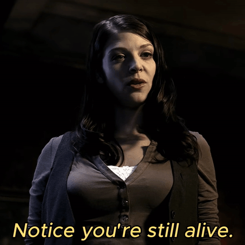 A Woman Says Notice You 'Re Still Alive In Yellow Letters GIF