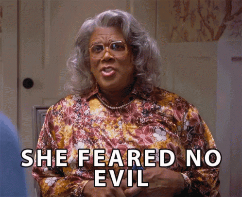 A Woman Says She Feared No Evil While Wearing Glasses And A Floral Shirt GIF
