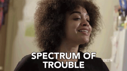 A Woman Says Spectrum Of Trouble In Front Of A Bet Logo GIF