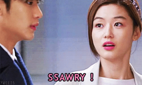 A Woman Says Ssawry While Looking At A Man In A Suit GIF