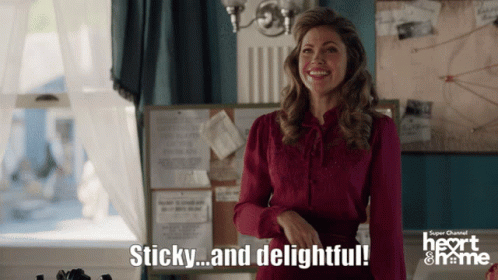 A Woman Says Sticky And Delightful In Front Of A Super Channel Sign GIF