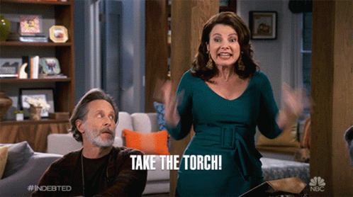 a woman says take the torch while a man looks on