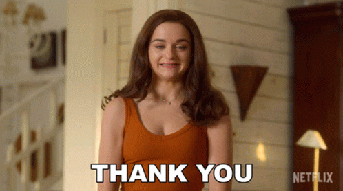 A Woman Says Thank You In Front Of A Netflix Sign GIF