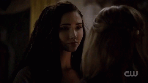 a woman says " thank you talon " to another woman in a dark room
