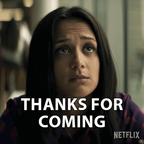 A Woman Says Thanks For Coming With A Netflix Logo Behind Her GIF