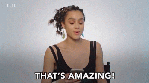 A Woman Says That 'S Amazing While Holding A Cell Phone GIF
