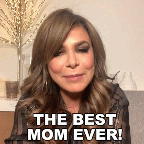 A Woman Says " The Best Mom Ever " In Front Of A Vase Of Candles GIF