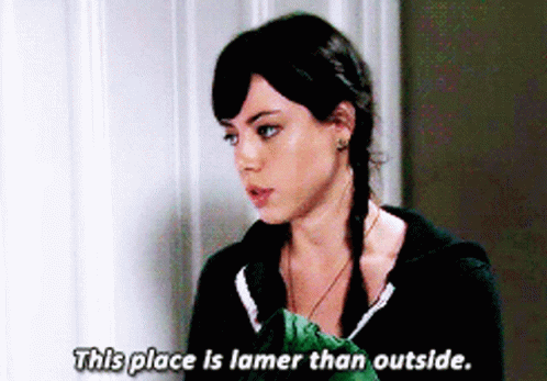A Woman Says " This Place Is Lamer Than Outside " In Front Of A Wall GIF