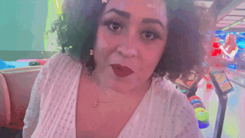 A Woman Says " U Heard Me " In Front Of A Pinball Machine GIF