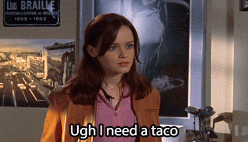 A Woman Says Ugh I Need A Taco In Front Of A Sign For Liz Braille GIF