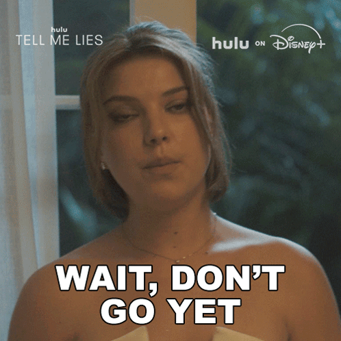 A Woman Says " Wait Don 'T Go Yet " In Front Of A Hulu Logo GIF