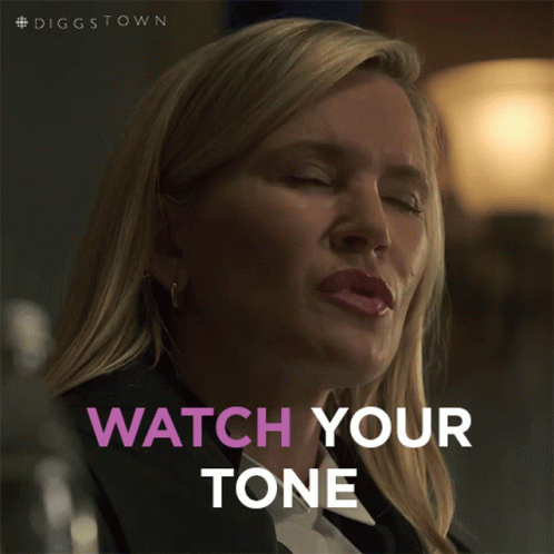 A Woman Says Watch Your Tone While Looking Down At Something GIF