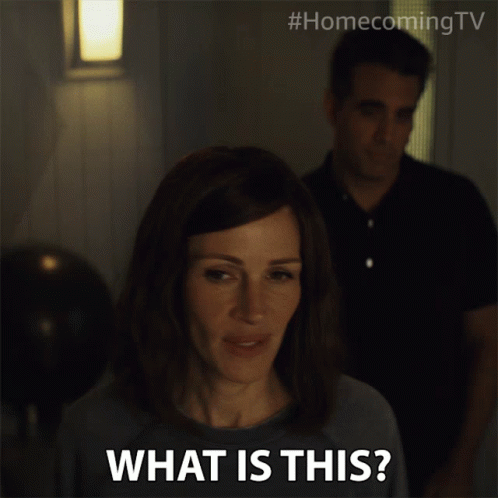 A Woman Says What Is This While A Man Stands In The Background GIF