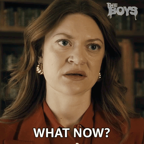 A Woman Says What Now In Front Of A Poster For The Boys GIF