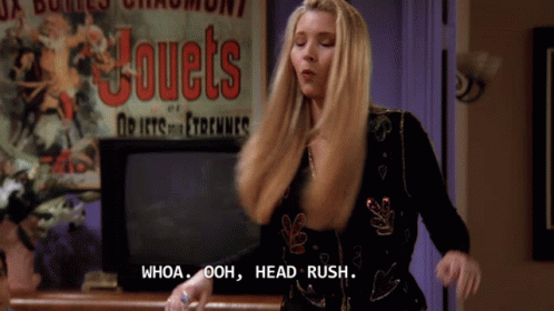 A Woman Says Whoa Ooh Head Rush In Front Of A Sign That Says Jouets GIF
