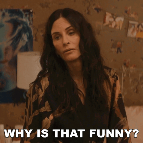 A Woman Says Why Is That Funny In Front Of A Wall Of Pictures GIF