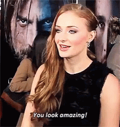A Woman Says " You Look Amazing " In Front Of A Man 'S Face GIF