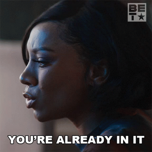 A Woman Says " You 'Re Already In It " In Front Of A Bet Logo GIF