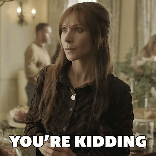 A Woman Says You 'Re Kidding While Standing In Front Of A Table GIF