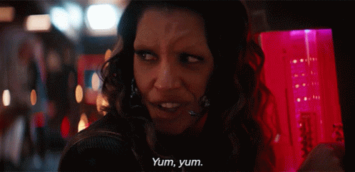 A Woman Says Yum Yum In Front Of A Pink Container GIF