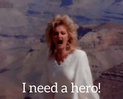 A Woman Singing In Front Of A Mountain With The Words I Need A Hero GIF