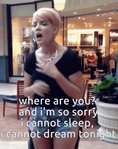 A Woman Singing In Front Of A Store That Says ' Where Are You ' GIF