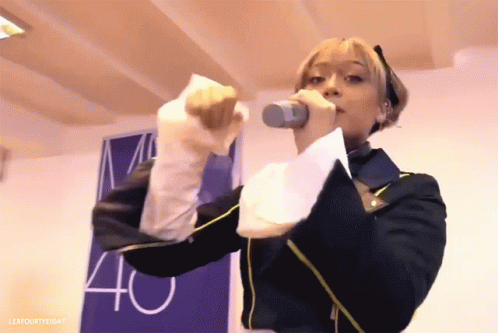 Woman Singing Into Microphone With 40 Sign GIF