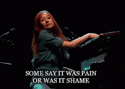 Woman Singing Into Microphone While Playing Piano GIF
