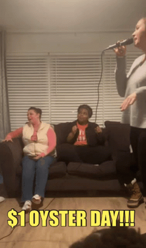 A Woman Singing Into A Microphone With $ 1 Oyster Day Written On The Bottom GIF