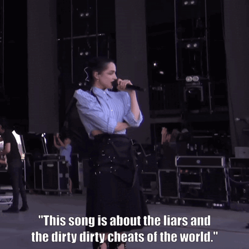 A Woman Singing Into A Microphone With A Caption That Says This Song Is About The Liars GIF