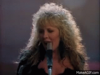 A Woman Singing Into A Microphone With Makeagif.com Written On The Bottom GIF