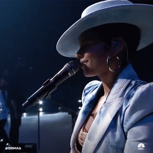 A Woman Singing Into A Microphone With The Hashtag #Bbmas On The Bottom Right GIF