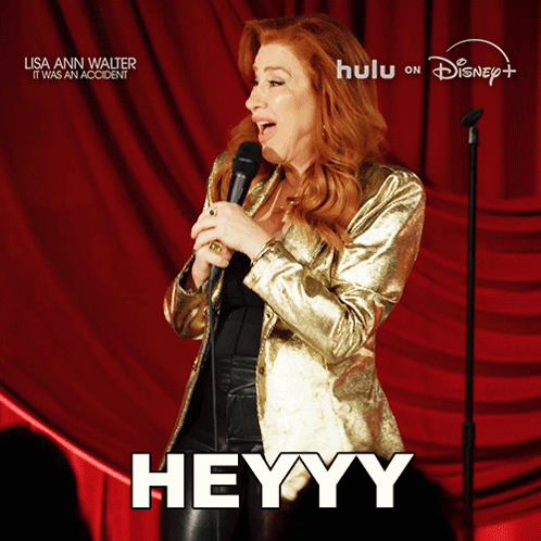 A Woman Singing Into A Microphone With The Word Heyy On The Bottom GIF