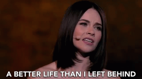 A Woman Singing Into A Microphone With The Words " A Better Life Than I Left Behind " Behind Her GIF