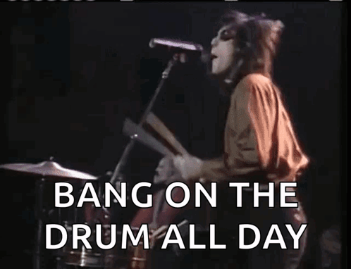 A Woman Singing Into A Microphone With The Words Bang On The Drum All Day Written Below Her GIF