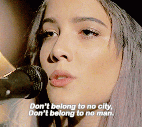 A Woman Singing Into A Microphone With The Words " Don 'T Belong To No City " GIF