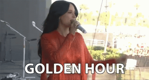 A Woman Singing Into A Microphone With The Words Golden Hour Written Below Her GIF