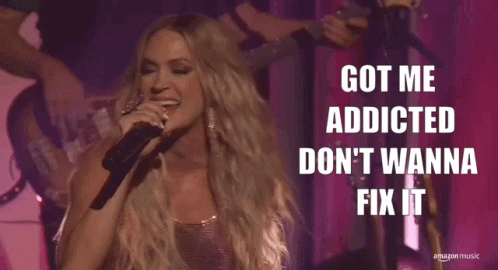 A Woman Singing Into A Microphone With The Words Got Me Addicted Don 'T Wanna Fix It Above Her GIF