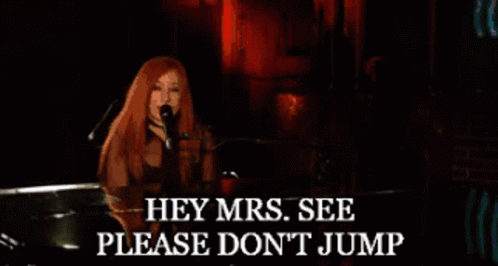 Woman Singing Into Microphone With Hey Mrs Please Don't Jump Text GIF
