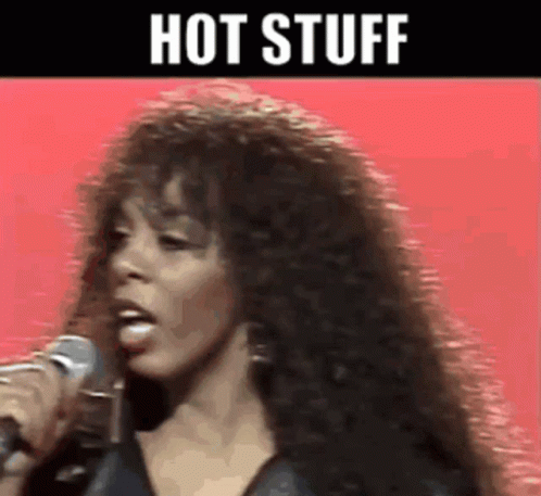 A Woman Singing Into A Microphone With The Words Hot Stuff Written Above Her GIF