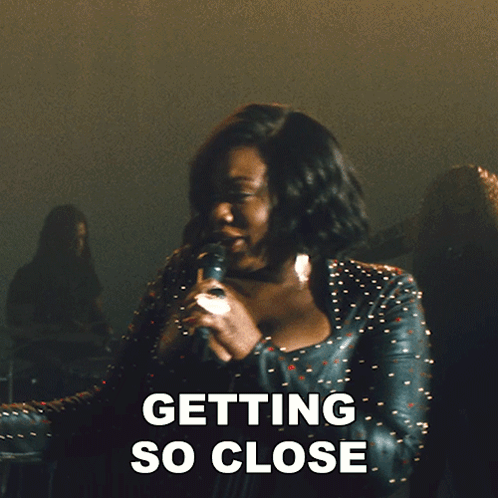 a woman singing into a microphone with the words " i can feel all the butterflies " below her