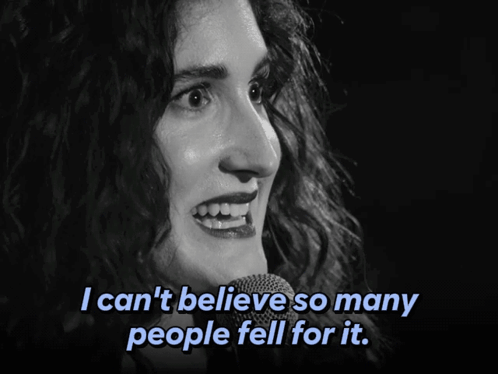 A Woman Singing Into A Microphone With The Words I Can 'T Believe So Many People Fell For It Below Her GIF