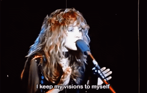 A Woman Singing Into A Microphone With The Words " I Keep My Visions To Myself " Below Her GIF