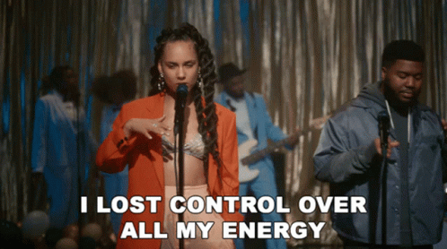A Woman Singing Into A Microphone With The Words " I Lost Control Over All My Energy " Behind Her GIF