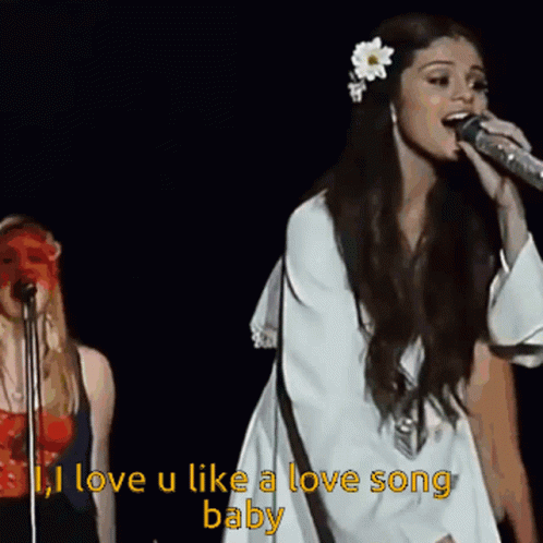 A Woman Singing Into A Microphone With The Words " I Love U Like A Love Song Baby " GIF