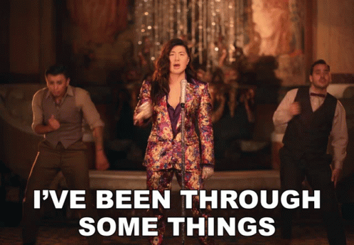 A Woman Singing Into A Microphone With The Words " I 'Ve Been Through Some Things " Below Her GIF
