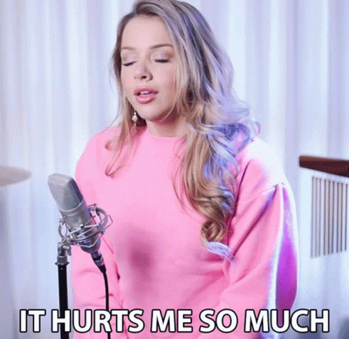 A Woman Singing Into A Microphone With The Words " It Hurts Me So Much " Above Her GIF