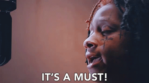 A Woman Singing Into A Microphone With The Words " It 'S A Must " Written Below Her GIF